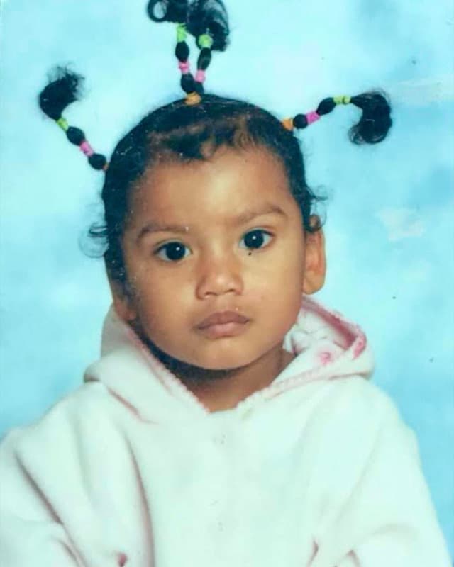 Me as a toddler, hair up in little bobbles